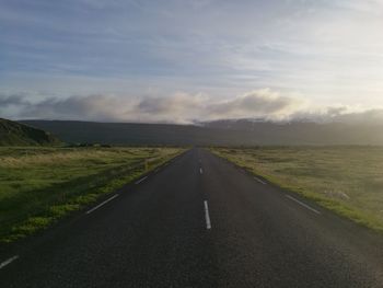 Road passing through landscape against sky