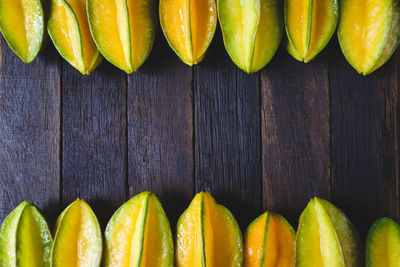 High angle view of starfruits arranged on wooden table