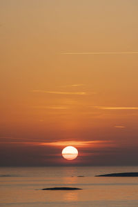 Scenic view of sea against orange sky