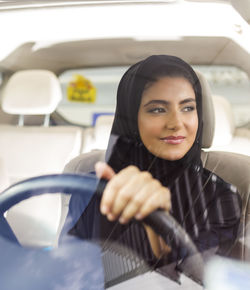 Woman wearing burka while driving car
