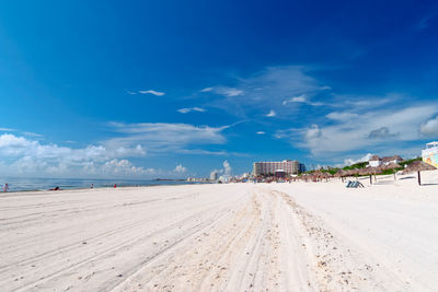 Scenic view of beach against blue sky