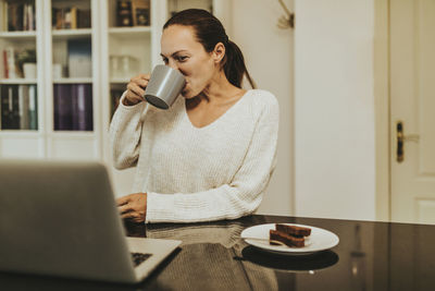 Woman using laptop on table