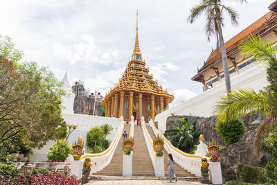 People outside temple against building