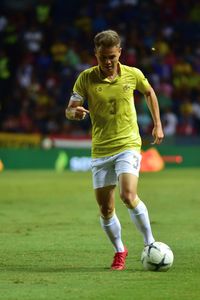 Full length of man running on soccer field