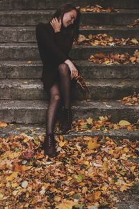 Full length of teenage girl sitting on staircase