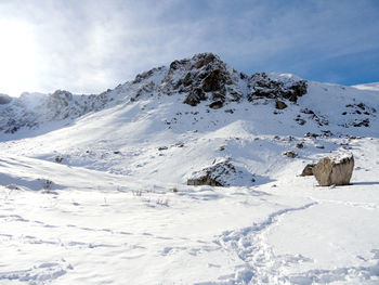 Scenic view of snow covered mountains against sky