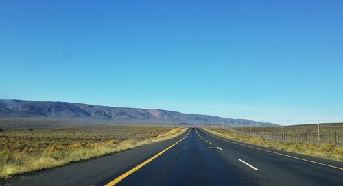 Country road leading towards mountains