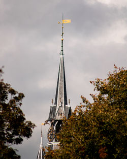 Low angle view of building against cloudy sky