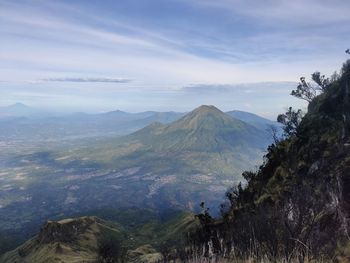 Scenic view of mountains against cloudy sky