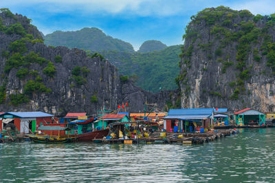 Scenic view of river and mountains against sky