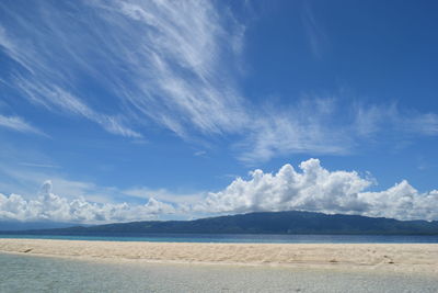 Scenic view of sea against cloudy sky