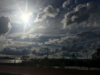 Low angle view of street against bright sun