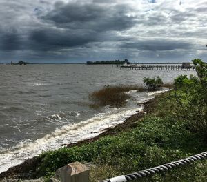 Scenic view of sea against cloudy sky