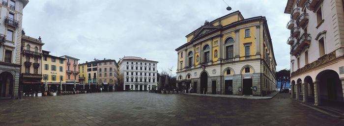 Street amidst buildings in town against sky