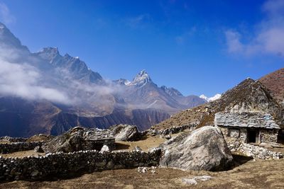 Scenic view of mountains against blue sky