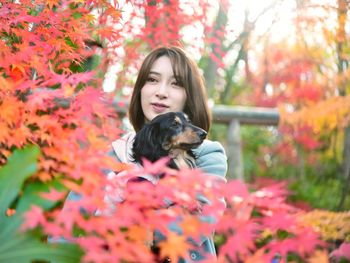 Portrait of woman with dog in autumn