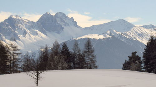 Scenic view of snow covered mountains against sky