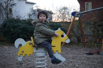 Portrait of cute boy with toy on playground