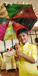 Portrait of smiling boy holding umbrella