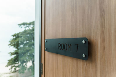 Close-up of text on wooden door