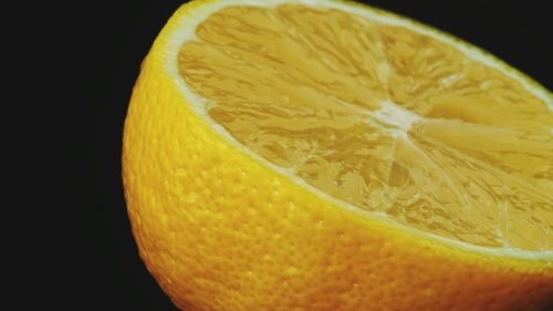 Close-up of lemon against black background