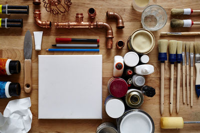 Directly above shot of work tools and plumbing equipment on wooden table