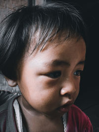 Close-up portrait of cute girl looking away