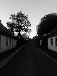 Empty road along houses