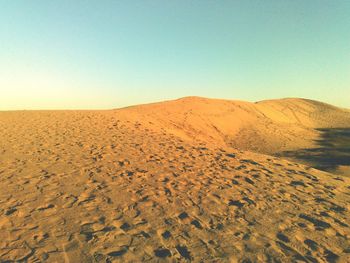 Scenic view of desert against clear sky