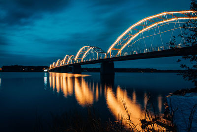 View of bridge over river at night