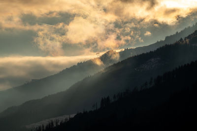 Scenic view of silhouette mountains against sky during sunset