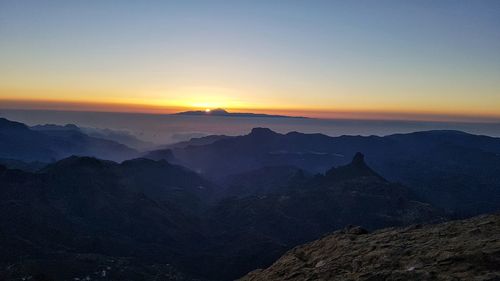 Scenic view of silhouette mountains against sky during sunset