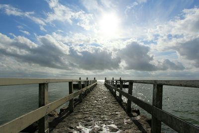 Pier over sea against sky