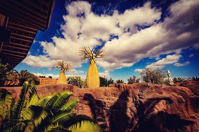 Palm trees and buildings against sky