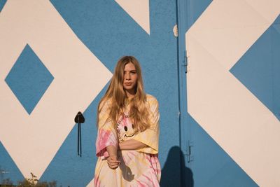 Woman standing against wall