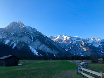 Scenic view of snowcapped mountains against clear blue sky