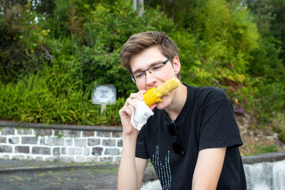 Portrait of young man eating food