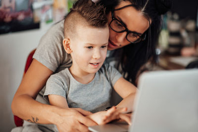 Close-up of boy using mobile phone