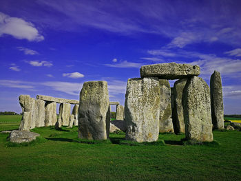 Stone structure on field against sky