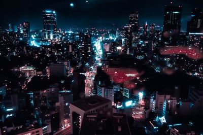 High angle view of illuminated city buildings at night