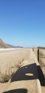 Scenic view of desert against clear blue sky