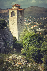 Castle by tree mountain against sky