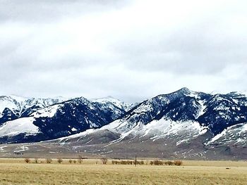 Scenic view of snow covered mountains against sky