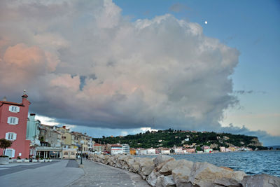 Panoramic view of buildings and sea against sky