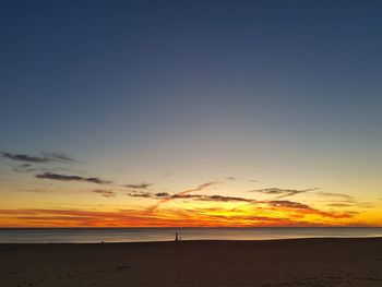 Scenic view of beach against sky during sunset