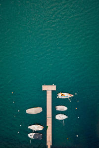 Lugano lake in the summer with the boats taken with a drone of the green water during the covid19