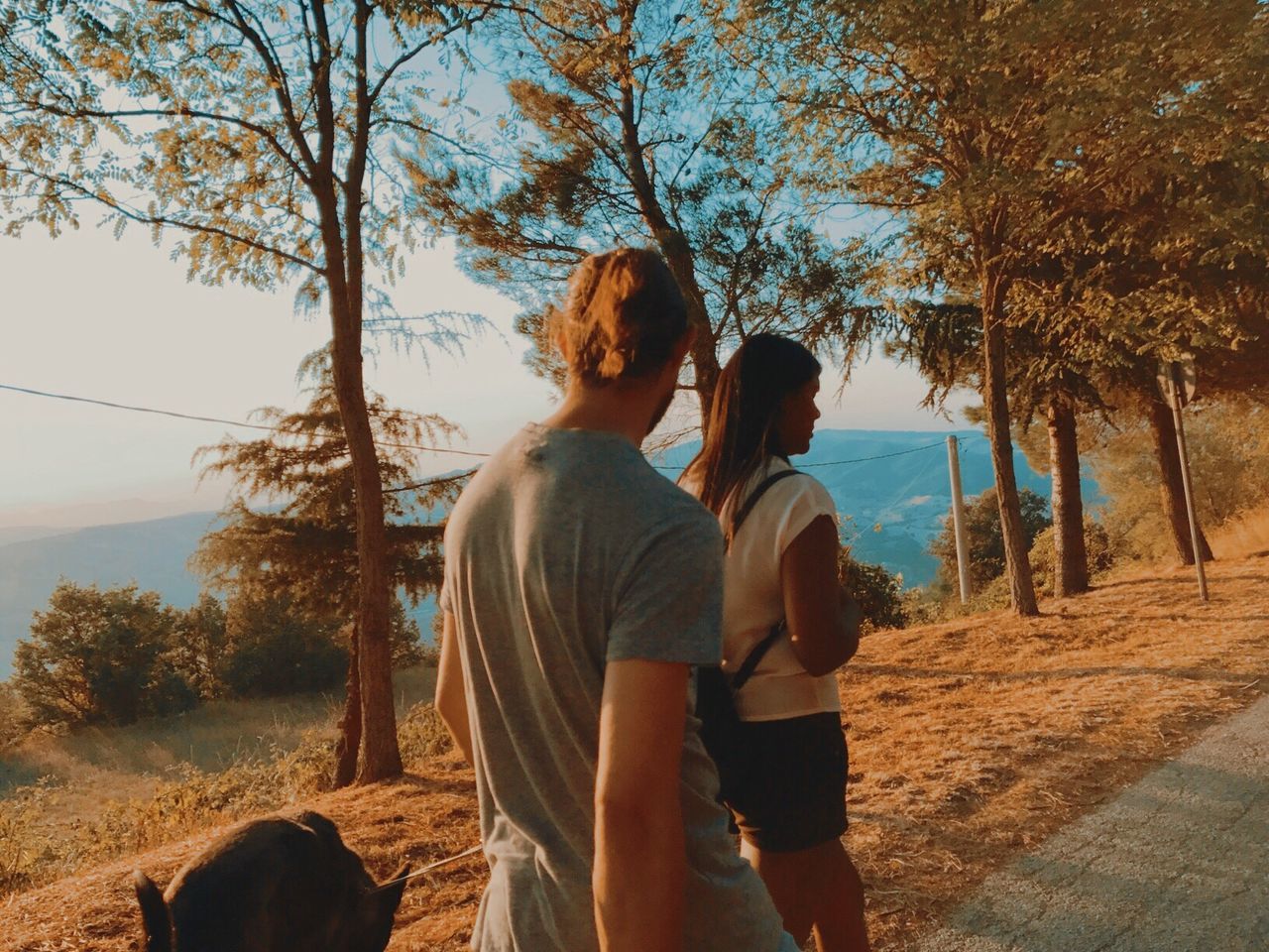 real people, two people, rear view, togetherness, tree, love, couple - relationship, leisure activity, nature, bonding, casual clothing, outdoors, lifestyles, day, standing, landscape, sky, men, scenics, women, beauty in nature, mammal, people