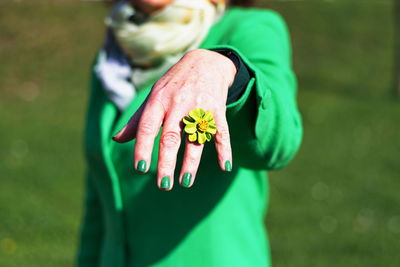 Midsection of woman standing by plant