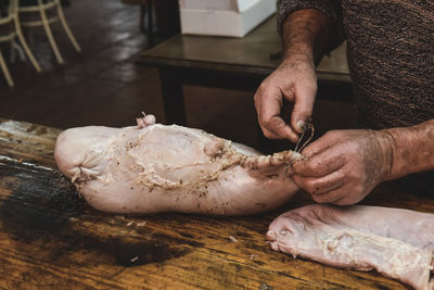 Cropped hand of man preparing food