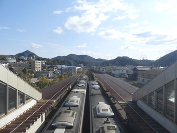 High angle view of railroad tracks in city against sky